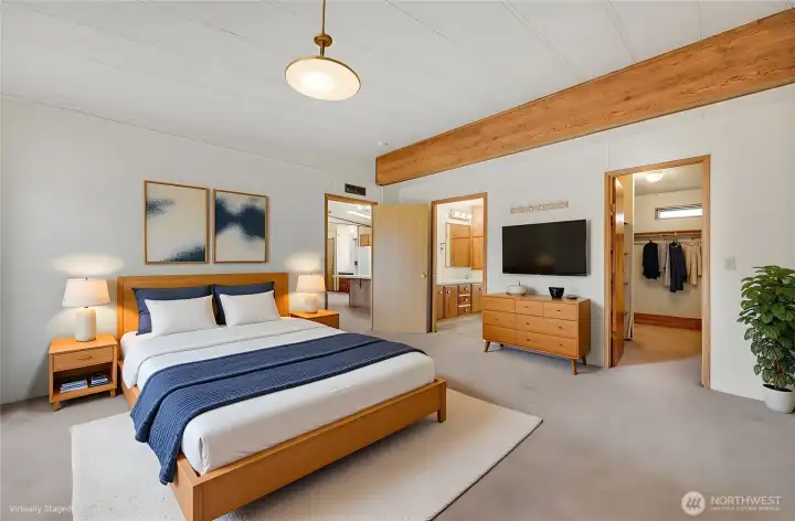 Another picture of the virtually staged primary suite, door on the right goes to large walk-in closet, door on the left goes to primary bathroom.