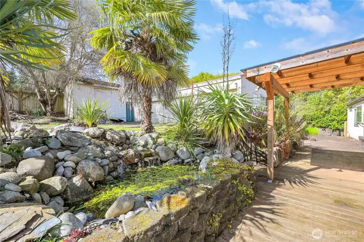 The back deck with the peaceful water features a waterfall creating a wonderful Zen feel. This home has it all!!