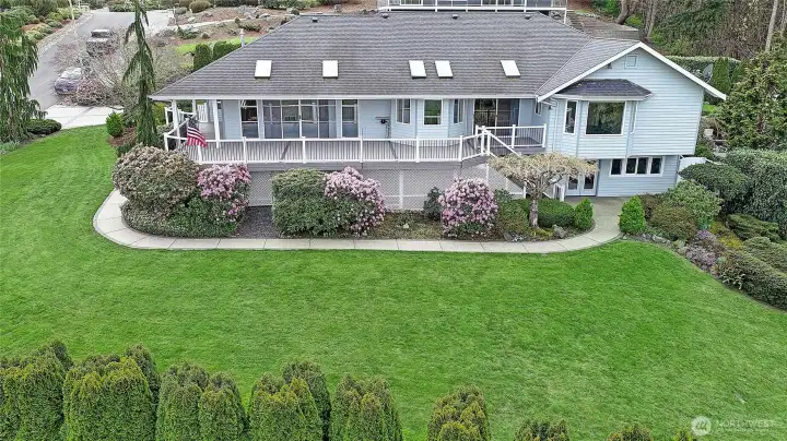 Spacious yard paired with an elevated deck, perfect for outdoor living.