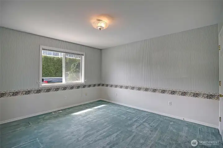 Well-sized guest bedroom with classic charm.