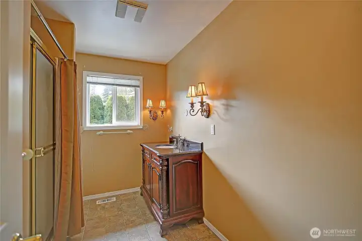 Guest bath featuring walk-in shower and classic vanity.