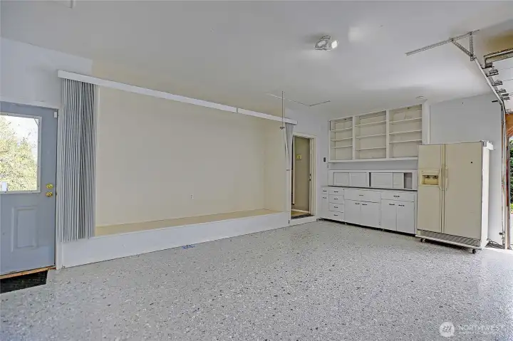 Large garage featuring ample storage and functional built-ins.