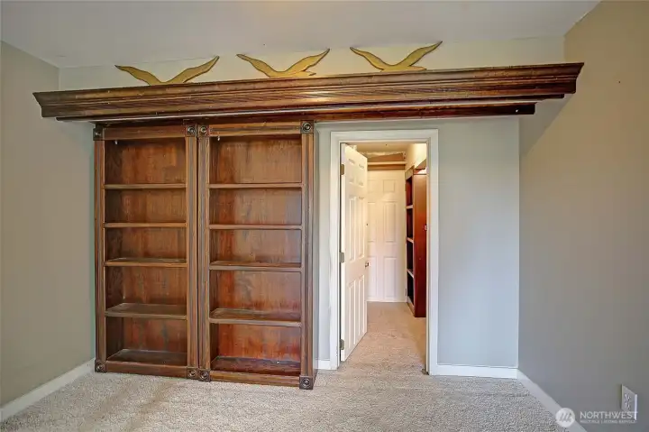 Built-in shelving with concealed access. Function meets creativity.