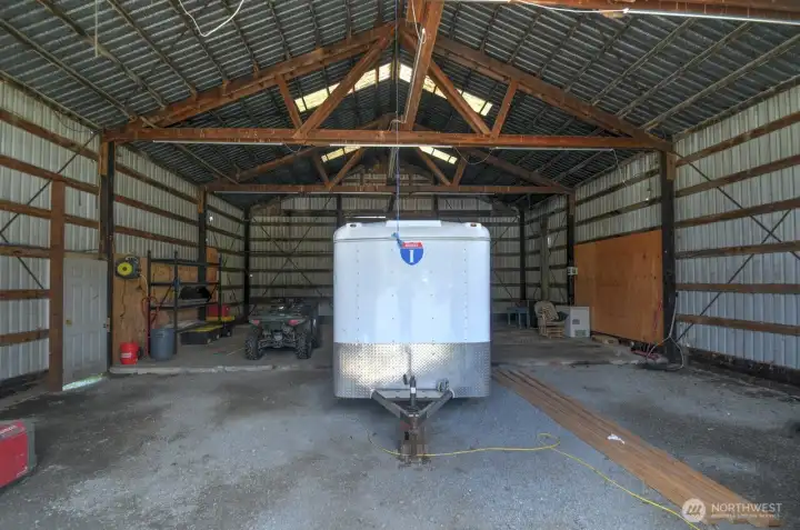 inside of metal building, cement floor, back sliding door to field, side door, skylight, there is a place for woodstove as well