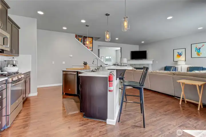 This open concept gets great natural light and will feel bright and cheery.  There's plenty of space for everyone to enjoy the gas fireplace when the weather cools down.