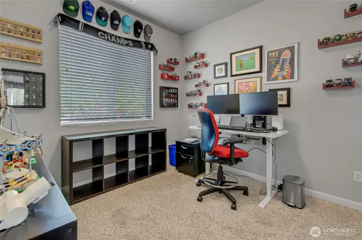 This bedroom is located on the main floor and is currently being used for an office.
