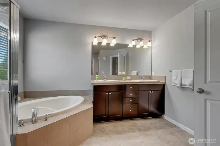 The luxury primary bath has double vainities, nice storage sapce and a soaking tub.