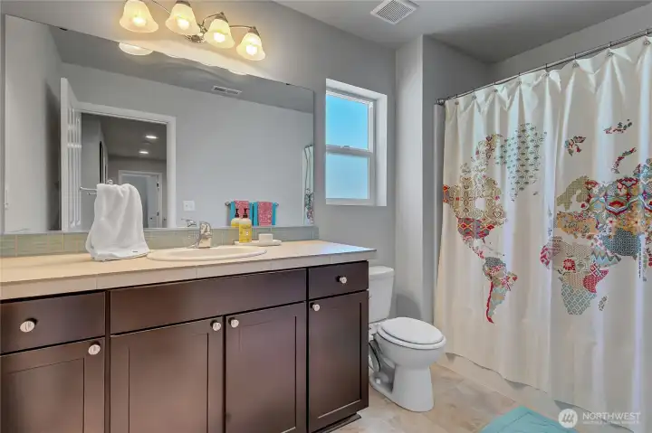A large upstairs full bath is conveniently located between the bedrooms upstairs.