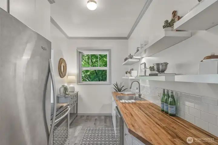 Cooks will appreciate the stainless-steel appliances & natural wood countertops.