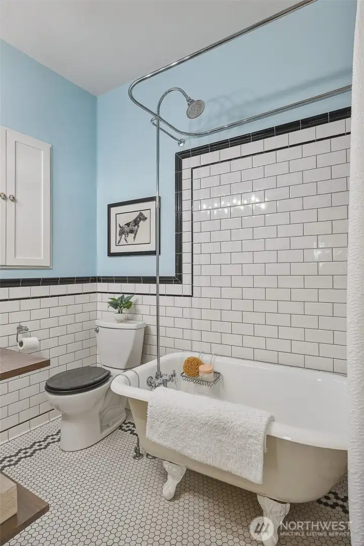 Clawfoot tub & exquisite tile work in the bathroom.