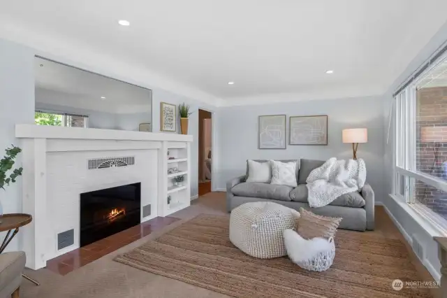 Gorgeous fireplace with built-in surrounds is currently electric but can be converted back to wood.