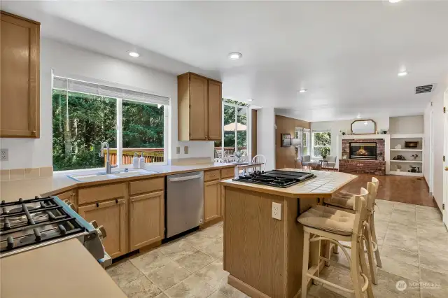 This kitchen is it! So much storage in the abundant cabinets, separate pantry. Entertain with ease with the extra cooktop on the island with seating.