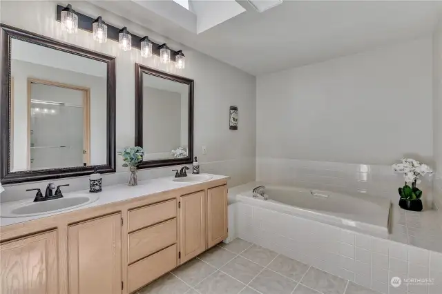 Primary en suite with soaking tub, separate shower room, double sinks and skylight.