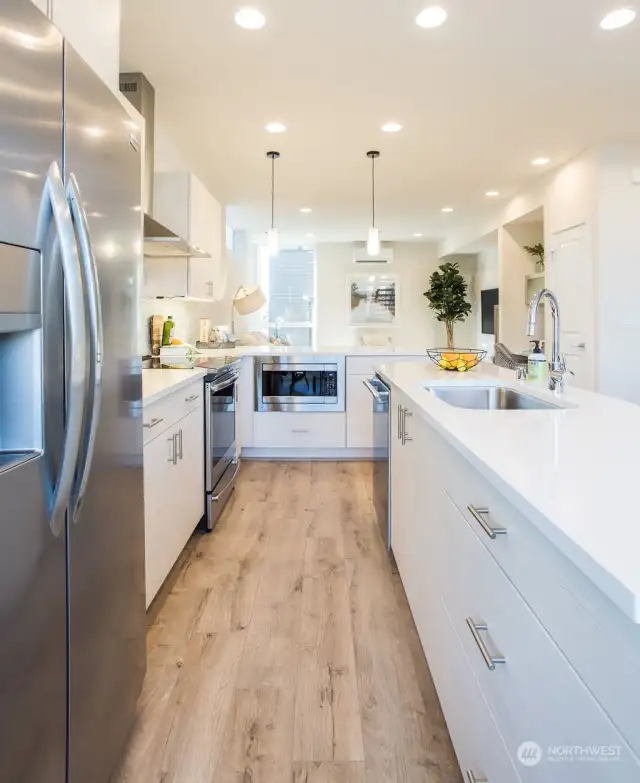 Large kitchens in both plans.  Each kitchen features BOTH an island AND peninsula + stainless appliance package + stone backsplash + quartz-topped counters + amazing storage + under cabinet lighting + separate dining spaces.