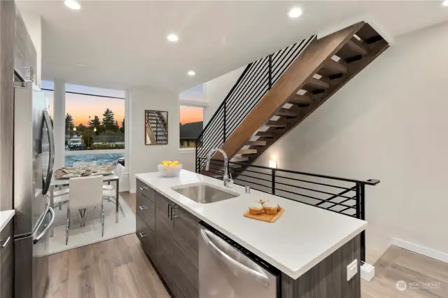 Large kitchens in both plans.  Each kitchen features BOTH an island AND peninsula + stainless appliance package + stone backsplash + quartz-topped counters + amazing storage + under cabinet lighting + separate dining spaces.