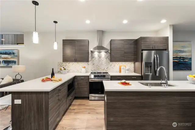 Large kitchens in both plans.  Each kitchen features BOTH an island AND peninsula + stainless appliance package + stone backsplash + quartz-topped counters + amazing storage + under cabinet lighting + separate dining spaces.