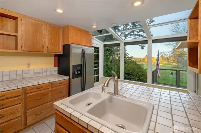 The kitchen with center island and eating space in the solarium.