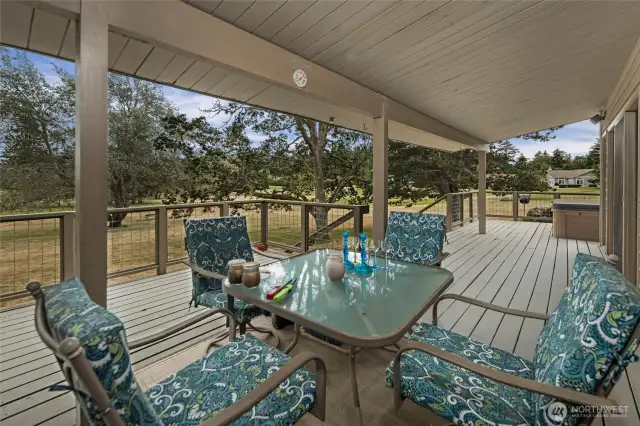 The partially covered extensive deck expands the living space to the outdoors. Enjoy views of the gorgeous Garry Oaks, the golf course, Cascades, Mount Baker and glimpses of Griffin Bay.