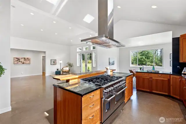 Kitchen with cherry cabinets, propane range, granite counters, stainless appliances.