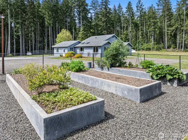 This single level, custom home has so much to offer including a fully fenced garden area with raised beds and an orchard of 20+ fruit trees!