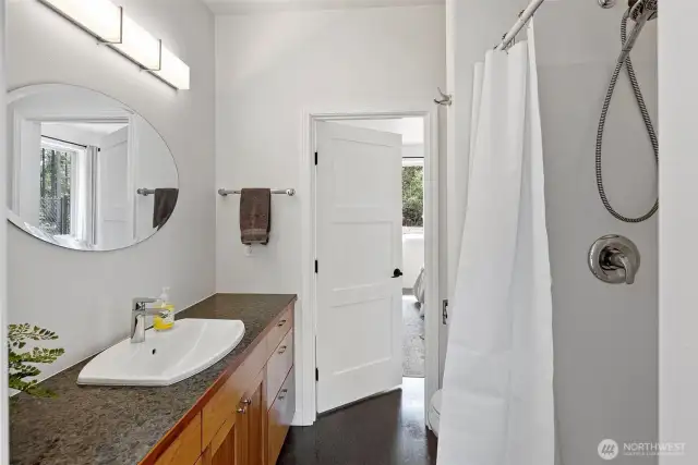 Junior suite bathroom. Can also be accessed from mudroom side so if you are entertaining on the back patio, guests don't need to walk thru the whole house to access a bathroom.