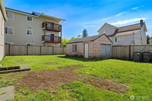 Detached vintage garage is accessible through the alley-way.
