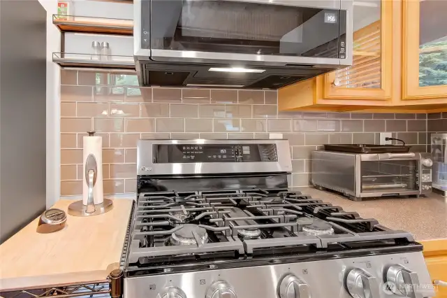 Kitchen upgrades include new SS appliances and glass tile back splash.