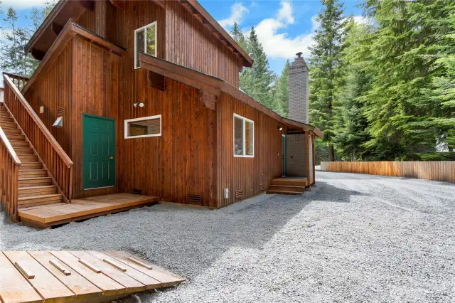 Back of home showing staircase to upper deck.