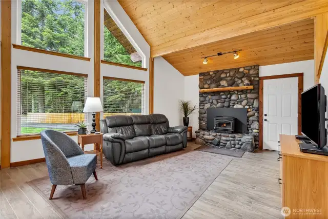 Pine-lined ceiling & river rock hearth finish the great room.