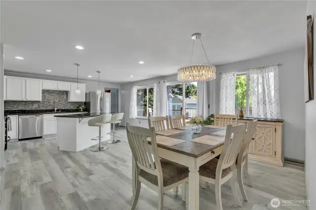 Open concept living room and kitchen with sliding door to back deck