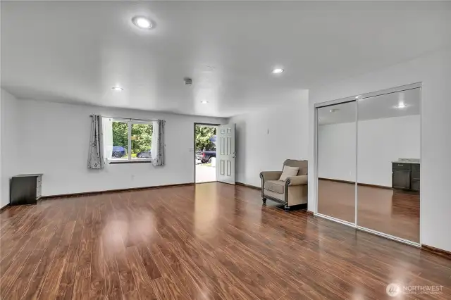 Extended family room with kitchenette type cabinets, with separate entrance