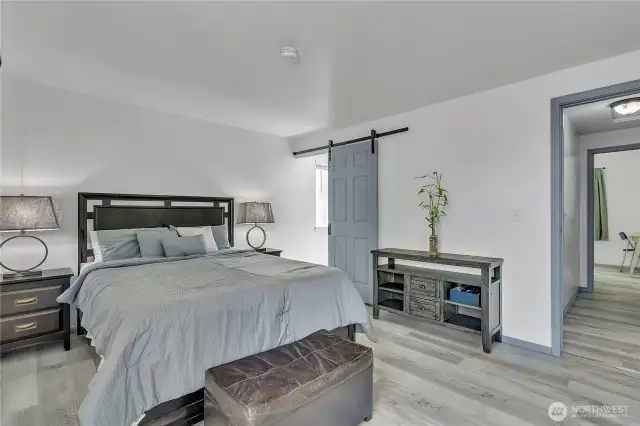 Primary bedroom with barn door to bathroom