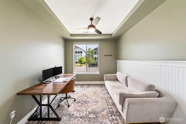 Den with custom features and French doors