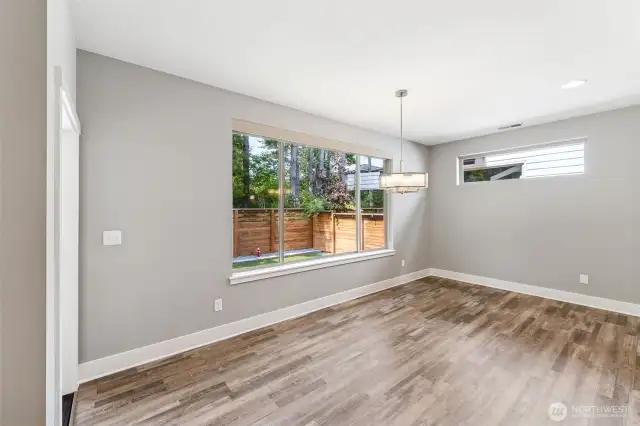 Dining area that looks over the backyard and greenbelt