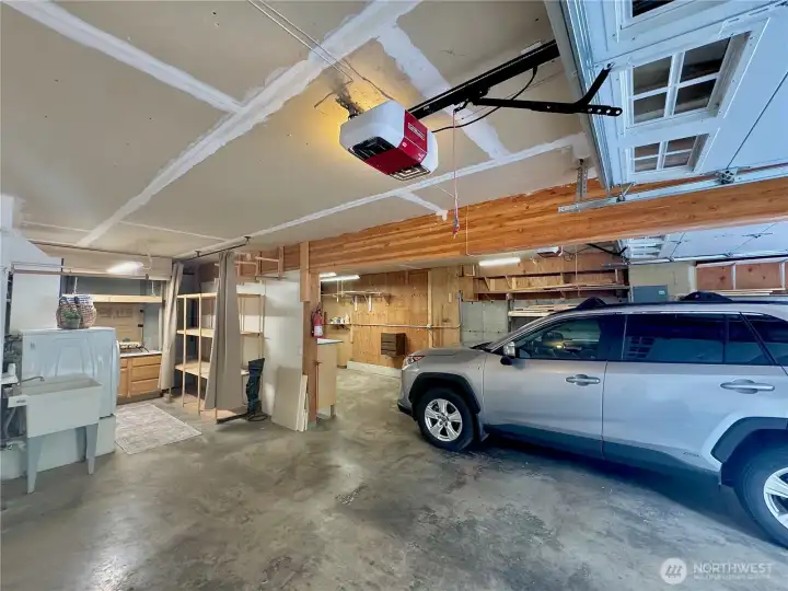 Space for 2-3 cars, and laundry area with shelving
