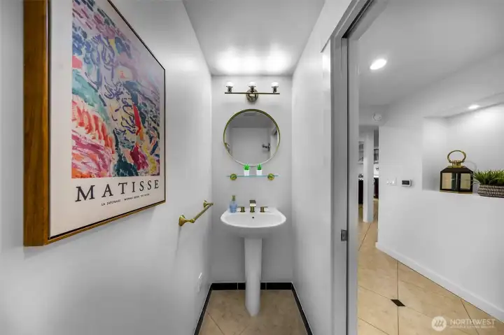 Powder room with new hardware located on the main floor away from the kitchen.