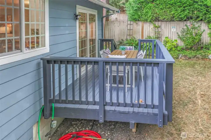 From the side view, the deck’s convenient access to the home through sliding glass doors makes outdoor living easy and inviting.
