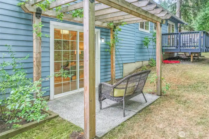 Another angle of the pergola highlights its connection to the home through sliding glass doors. This thoughtful design expands the living area into the backyard.