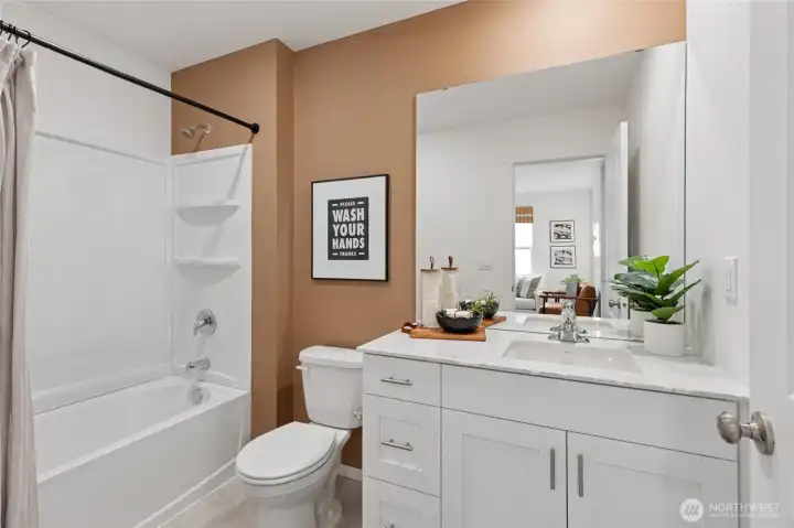 “Well-appointed hall bath with contemporary finishes.”