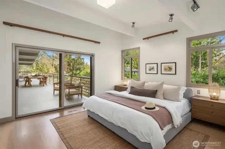 The main floor primary suite opens to the deck with beautiful garden views and sits adjacent to the library.