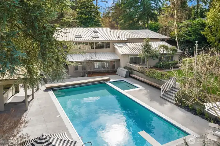 Outside, a cabana, pool, hot tub, shuffleboard, and backyard celebrate the very best of PNW living.