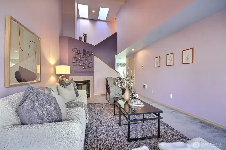 This generously sized living space offers a versatile layout for your largest sectionals and statement furniture, all framed by elegant high-sloped ceilings.