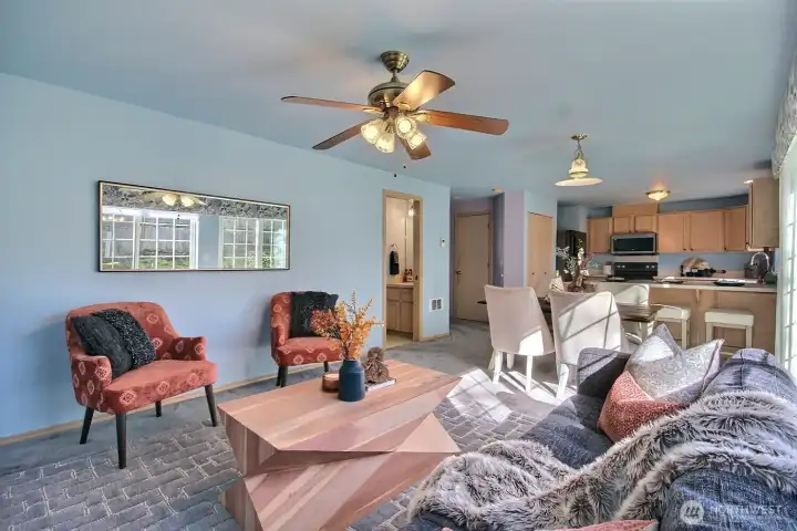 Enjoy effortless flow from the cozy family room to the adjacent dining area and well-appointed kitchen. The half barh can be seen in the photo on the left.