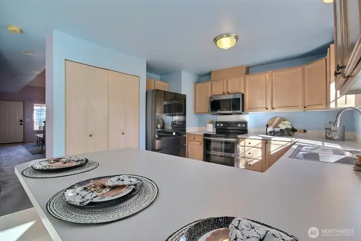 The kitchen features a Smart refridgerator, newer micro, electric stove/oven, dishwasher - all included, plus a double sink with garbage disposal.