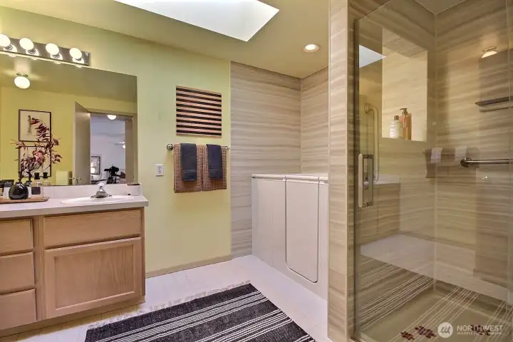 This 5-piece primary ensuite bathroom features a brand-new, deep-soaking jetted jacuzzi tub and a stunning, newly updated walk-in shower. It’s the ultimate space for relaxation and rejuvenation after a long day.