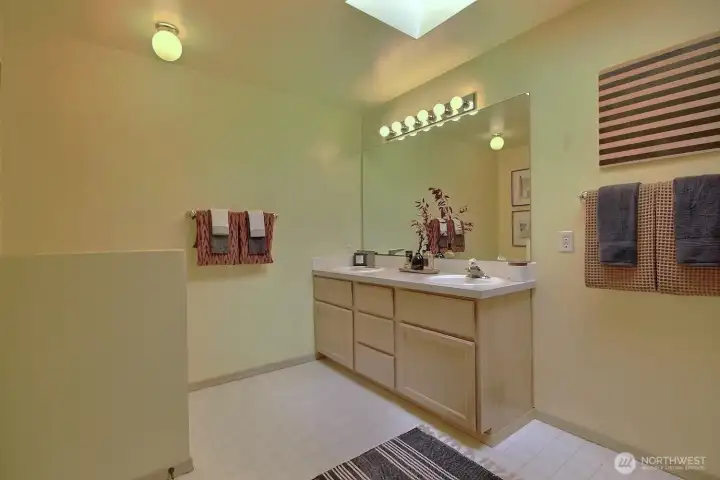 Enjpy the large vanity that offers an abundance of counter space and dual sinks, providing a seamless morning routine with plenty of room for two.  Plent of room for an additional storage piece or dresser bureau.