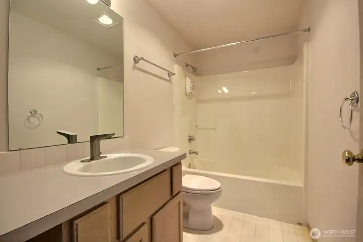 Upper level hall/guest bath has been hardly used.  It features a tub/shower and lots of counterspace.