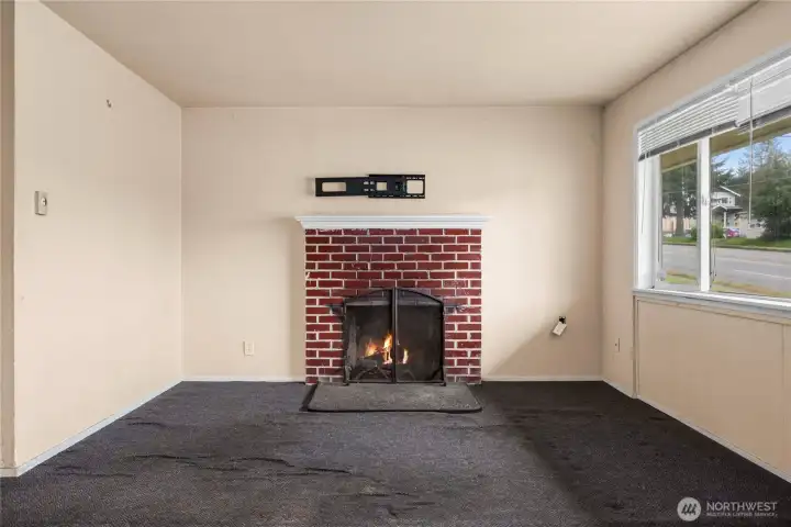 Living Room. Fire has been photoshopped into the fireplace. We do not know the condition of this woodburning fireplace!