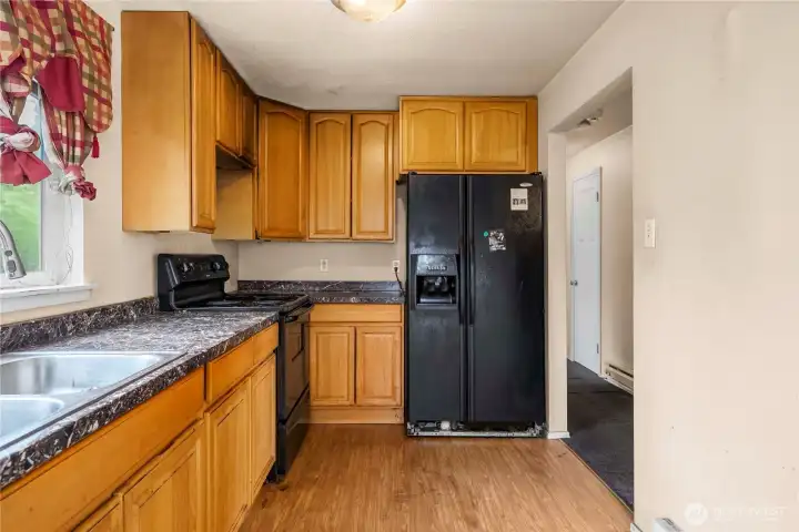 Kitchen as seen from the utility room. Hall on the right