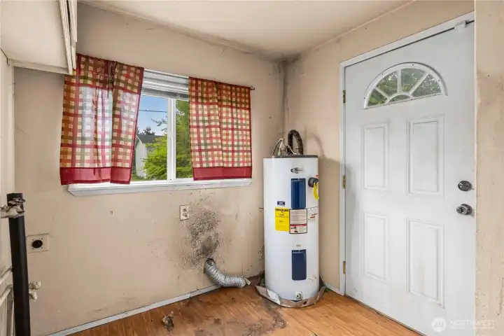 Utility room with back door as seen from the kitchen.
